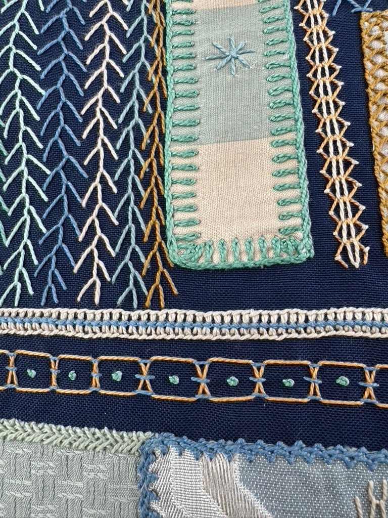 Rosas Design by Pamela Nelson. Hand embroidered on red Honduras Threads