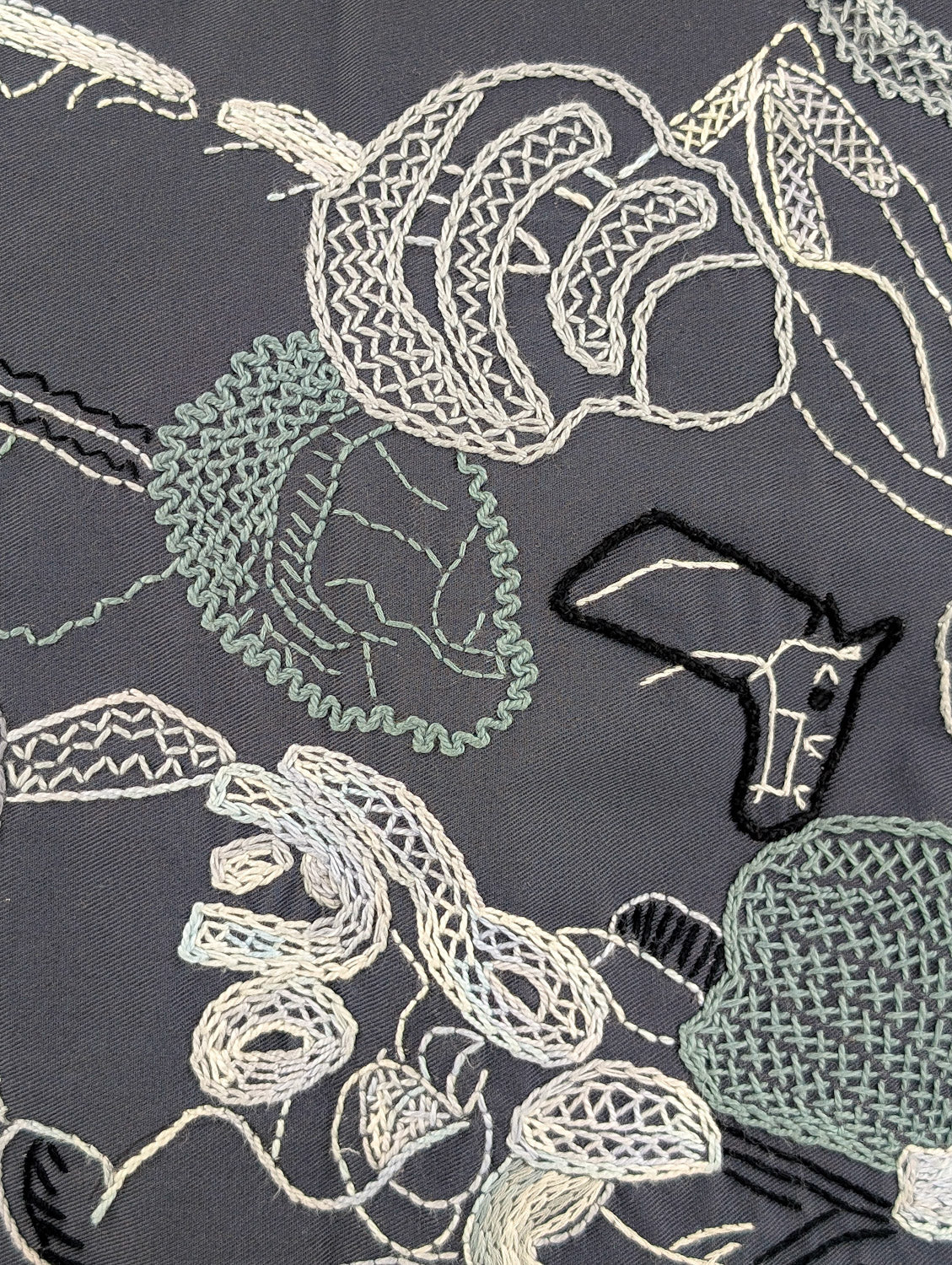 Abstract #2 Design by Terrell James. Hand Embroidered on grey Honduras Threads