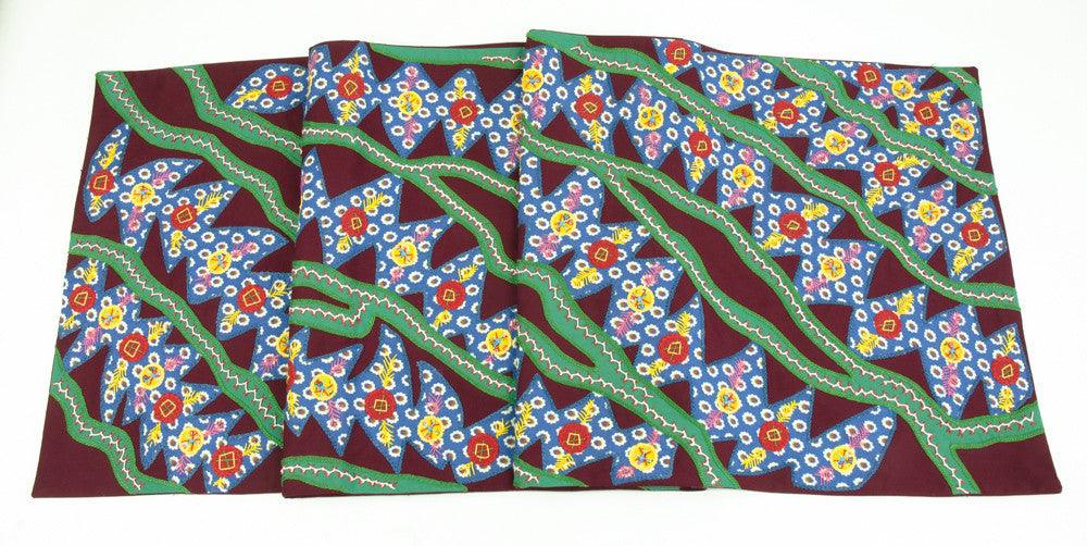 Hojas en el Rio Design Embroidered Table Runner on maroon Honduras Threads