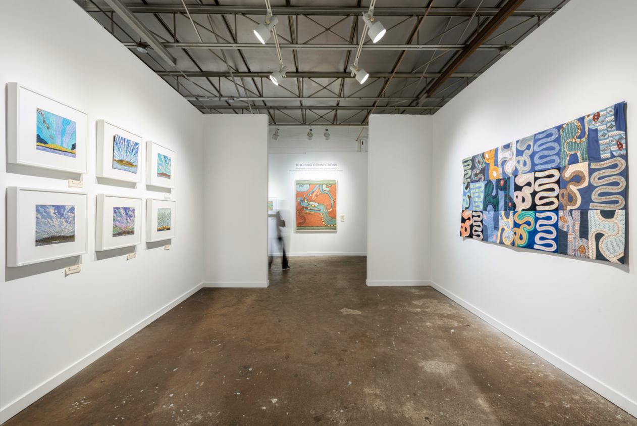 Art gallery with various artworks on white walls