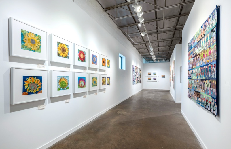 Art gallery with colorful paintings on white walls