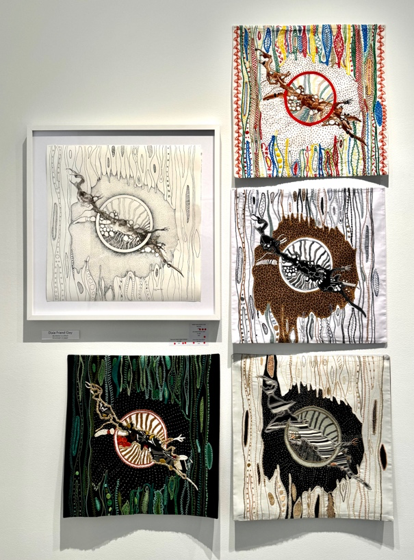 Collection of framed artworks on a white wall