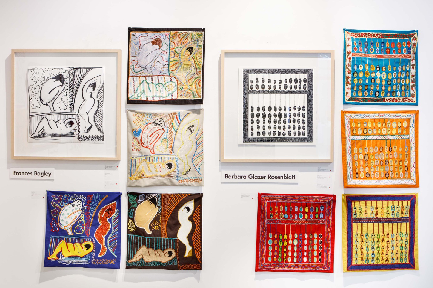 Collection of framed artworks on a white wall