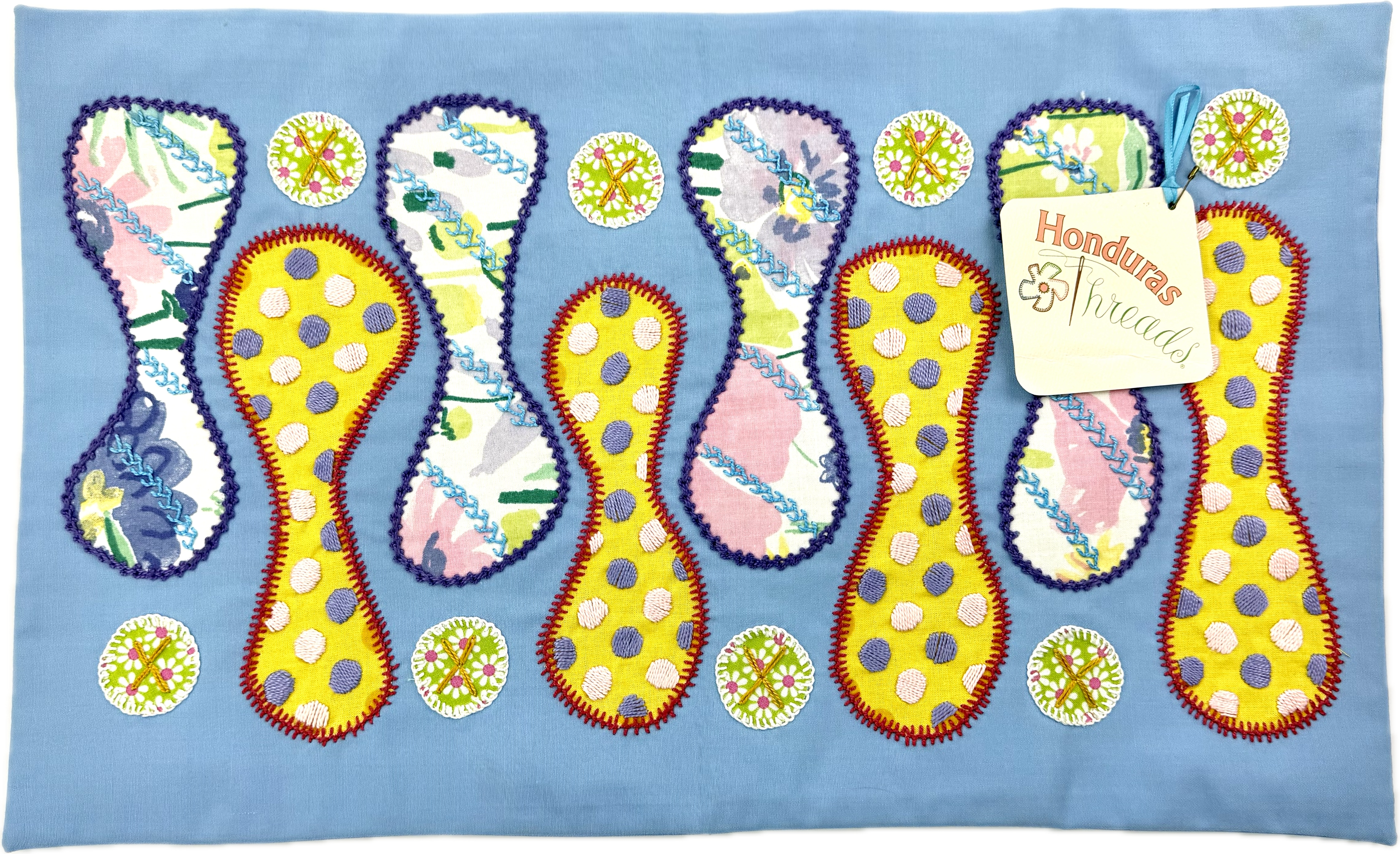 Zipper Design by Pamela Nelson.  Hand Embroidered on red. Pamela Nelson